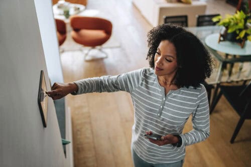woman adjusting smart home settings